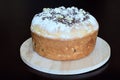 Fresh lush festive bread made from white flour with walnuts on wooden stand on dark background. Concept Ã¢â¬â culinary recipes,